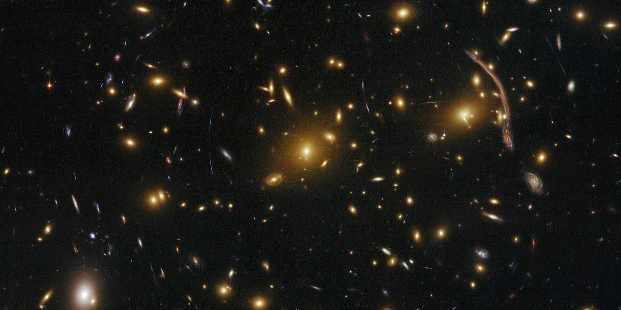 Image depicting gravitational lensing as research indicates that amount of dark matter is ten times more