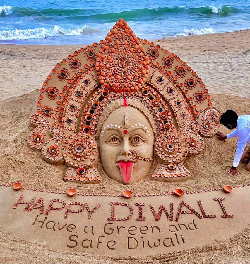 image depicting Artist creates sand art of Goddess Kali with earthen diyas