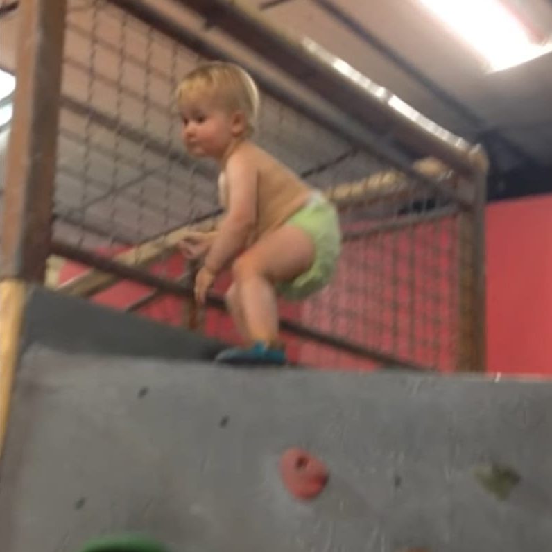 Image depicting A baby climbs the rock wall